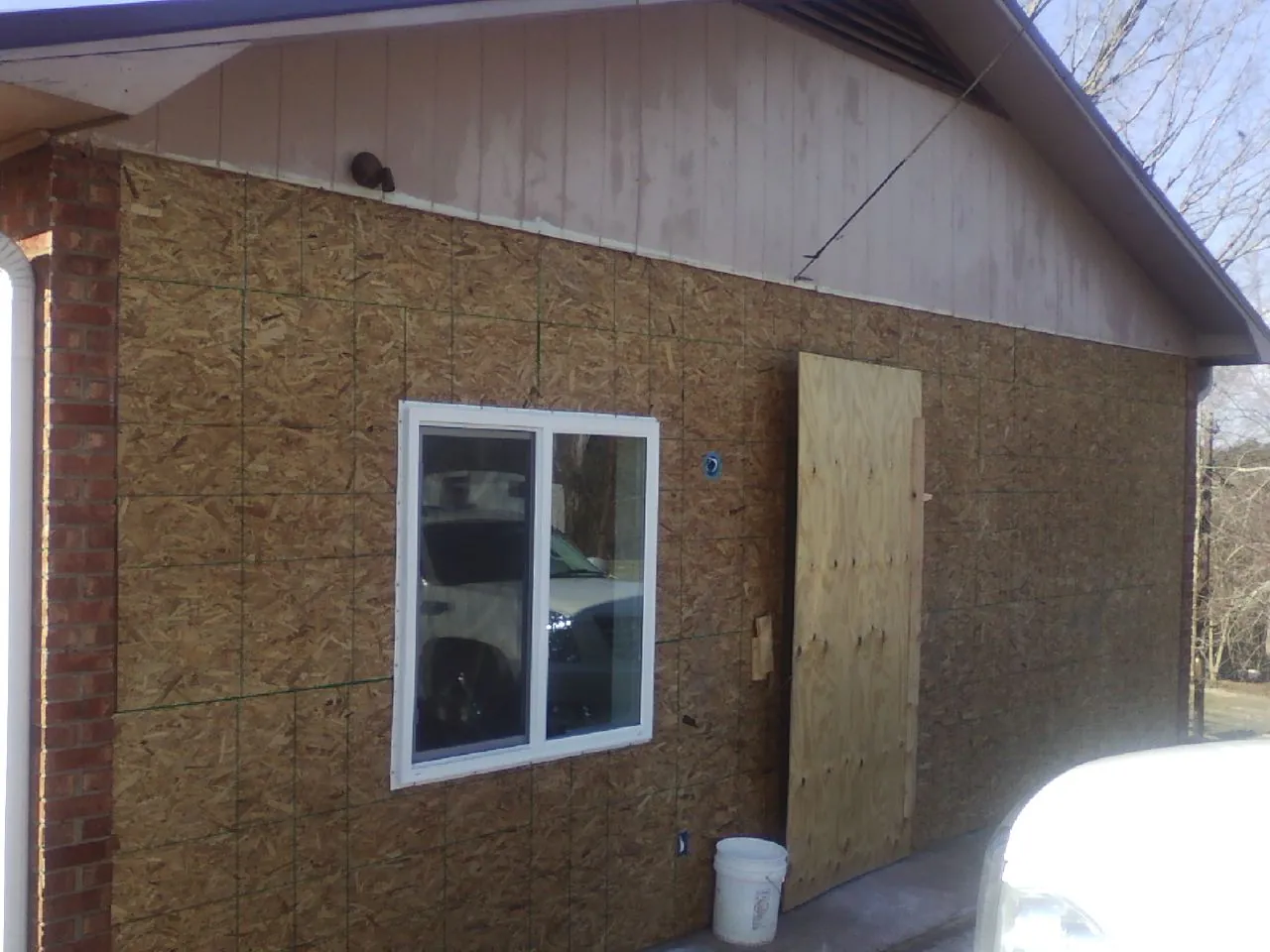 OSB sheathing on a garage addition wall before siding in Pomona